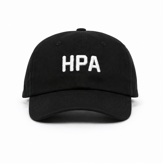 A black baseball cap with the letters 'HPA' embroidered in white on the front, shown against a plain white background.